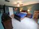 Comfortable bedroom features a bed, dark wood furniture, and a ceiling fan at 13156 Merlot Sunstone Cv, Parrish, FL 34219