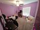 Bedroom with a ceiling fan, a desk, a bed, and a bookshelf, carpeted for comfort at 13156 Merlot Sunstone Cv, Parrish, FL 34219