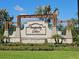 Stone sign for Prosperity Lakes community with lush landscaping and palm trees at 13156 Merlot Sunstone Cv, Parrish, FL 34219