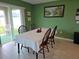 Dining room with a table set for four near sliding glass doors to the outside at 13156 Merlot Sunstone Cv, Parrish, FL 34219