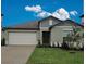 Charming single-Gathering home with a well-manicured lawn and an attached two-car garage, inviting curb appeal at 13156 Merlot Sunstone Cv, Parrish, FL 34219