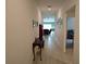 Long hallway with tile floors leads to a living room, creating an open and inviting space at 13156 Merlot Sunstone Cv, Parrish, FL 34219