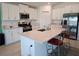 Bright kitchen features white cabinetry, stainless steel appliances, and a large island with seating at 13156 Merlot Sunstone Cv, Parrish, FL 34219