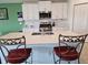 Beautiful kitchen featuring white cabinetry, quartz countertops, and a spacious island with seating at 13156 Merlot Sunstone Cv, Parrish, FL 34219