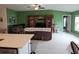 Spacious living room with large entertainment center and access to kitchen at 13156 Merlot Sunstone Cv, Parrish, FL 34219