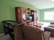 Spacious living room with a large entertainment center, comfortable seating, and lots of natural light at 13156 Merlot Sunstone Cv, Parrish, FL 34219