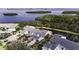 Stunning aerial view of a home near the water with lush greenery and beautiful landscaping at 1322 Perico Point Cir, Bradenton, FL 34209