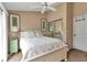 Neutral bedroom featuring a white bed frame, mirrored closet, and light green nightstand at 1322 Perico Point Cir, Bradenton, FL 34209