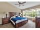 Spacious bedroom with vaulted ceiling, king bed, a large bay window providing ample natural light and backyard views at 1322 Perico Point Cir, Bradenton, FL 34209