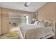 Bright bedroom featuring a sliding glass door to a patio, neutral walls, and ceiling fan at 1322 Perico Point Cir, Bradenton, FL 34209
