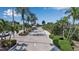 Long view of the gated community entrance featuring lush greenery and mature palm trees at 1322 Perico Point Cir, Bradenton, FL 34209