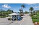 Gated community entrance with guard house, lush landscaping, and palm trees on a sunny day at 1322 Perico Point Cir, Bradenton, FL 34209