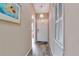 Inviting entryway with luxury vinyl floors, coat closet, neutral paint, and elegant lighting at 1322 Perico Point Cir, Bradenton, FL 34209