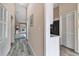 Inviting hallway with wood floors leads to the living area and kitchen with white trim at 1322 Perico Point Cir, Bradenton, FL 34209