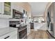 Updated kitchen featuring stainless steel appliances, white cabinets, and a wood-look floor at 1322 Perico Point Cir, Bradenton, FL 34209