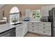 Bright kitchen featuring white cabinets, quartz countertops, and stainless steel appliances at 1322 Perico Point Cir, Bradenton, FL 34209