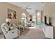 Bright living room with a ceiling fan and neutral tones, open to kitchen and dining areas at 1322 Perico Point Cir, Bradenton, FL 34209