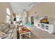 Inviting living room with vaulted ceilings, and modern furnishings offers comfort and style at 1322 Perico Point Cir, Bradenton, FL 34209
