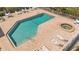 Aerial view of a pool with a spa, pool furniture and a white fence at 1322 Perico Point Cir, Bradenton, FL 34209