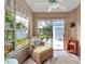 Cozy sunroom with wicker furniture, lots of light, and serene views of lush landscaping at 1322 Perico Point Cir, Bradenton, FL 34209