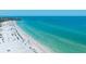 Gorgeous aerial of the beach with swimmers enjoying the white sands and ocean waters at 1350 N Portofino Dr # 208, Sarasota, FL 34242