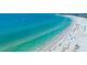 Expansive aerial view of pristine beach with white sands and clear turquoise waters at 1350 N Portofino Dr # 208, Sarasota, FL 34242
