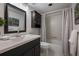 Nicely decorated bathroom with updated sink, vanity, and shower with decorative tile and shower curtain at 1350 N Portofino Dr # 208, Sarasota, FL 34242