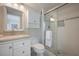 Clean bathroom with glass shower and sink with cabinets and drawers at 1350 N Portofino Dr # 208, Sarasota, FL 34242