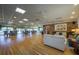 Large community room featuring ample seating, dining tables, a library, and wood flooring at 1350 N Portofino Dr # 208, Sarasota, FL 34242