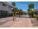 Gated community entrance with brick-paved driveway and lush tropical landscaping at 1350 N Portofino Dr # 208, Sarasota, FL 34242
