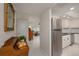 View of the entryway, kitchen with stainless appliances, and a glimpse into the living room at 1350 N Portofino Dr # 208, Sarasota, FL 34242