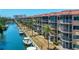 Condo with a waterfront view, screened balcony, and tropical landscaping at 1350 N Portofino Dr # 208, Sarasota, FL 34242