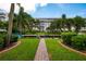 Beautiful condo exterior with lush landscaping, a path, and access to the docks and the waterfront at 1350 N Portofino Dr # 208, Sarasota, FL 34242