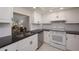 Bright kitchen features white cabinetry, granite countertops, and modern appliances at 1350 N Portofino Dr # 208, Sarasota, FL 34242
