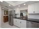 Modern kitchen with stainless steel refrigerator and view to the living area at 1350 N Portofino Dr # 208, Sarasota, FL 34242