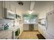 Bright white kitchen with modern appliances, tile backsplash, and ample counter space at 1350 N Portofino Dr # 208, Sarasota, FL 34242