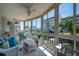 Relaxing screened lanai with lovely water view and comfortable wicker furniture at 1350 N Portofino Dr # 208, Sarasota, FL 34242