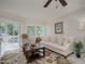 Bright and airy living room with a sliding door to the screened balcony at 1350 N Portofino Dr # 208, Sarasota, FL 34242