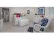 Airy bedroom with decorative throw pillows, light walls, and white wicker furniture at 1350 N Portofino Dr # 208, Sarasota, FL 34242