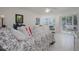 Cozy bedroom with white furniture and access to the screened lanai at 1350 N Portofino Dr # 208, Sarasota, FL 34242