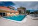 Inviting community pool with lounge chairs, offering the perfect spot to soak up the sun and enjoy the coastal lifestyle at 1350 N Portofino Dr # 208, Sarasota, FL 34242