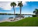 Waterfront view of the pier, benches and picnic table, perfect for relaxing and enjoying the scenery at 1350 N Portofino Dr # 208, Sarasota, FL 34242