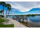 Community waterfront with a pier, seating and serene water views, perfect for residents to enjoy at 1350 N Portofino Dr # 208, Sarasota, FL 34242