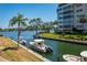 Beautiful waterfront view with boats docked along the condo property at 1350 N Portofino Dr # 208, Sarasota, FL 34242