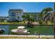 Scenic waterfront views, with boat docked along community, highlighting the coastal charm at 1350 N Portofino Dr # 208, Sarasota, FL 34242
