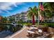 Community waterfront with tables, benches, and tropical landscaping to create a welcoming and enjoyable area at 1350 N Portofino Dr # 208, Sarasota, FL 34242