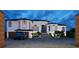 Stunning exterior view of a two-story home with a black roof, blue front door, and a 3-car garage at 1384 Harbor Dr, Sarasota, FL 34239