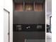 Modern kitchen with sleek black cabinetry and appliances, complete with a stylish, minimalist design at 1384 Harbor Dr, Sarasota, FL 34239