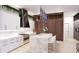 Bright kitchen with white cabinetry, marble countertops, modern appliances, and hardwood floors at 1384 Harbor Dr, Sarasota, FL 34239