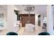 Bright kitchen with white cabinetry, marble island, modern appliances, and adjacent seating area at 1384 Harbor Dr, Sarasota, FL 34239